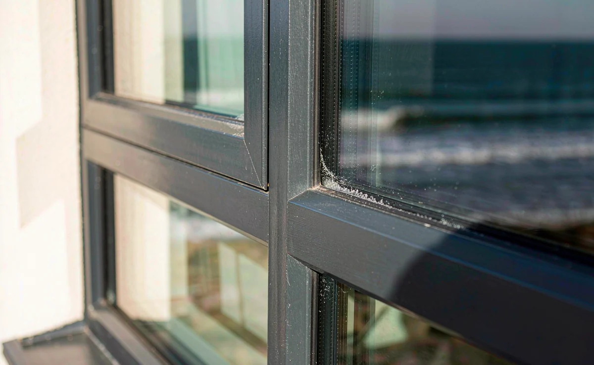 Salt crystals caught in the gasket channel of a coastal window frame