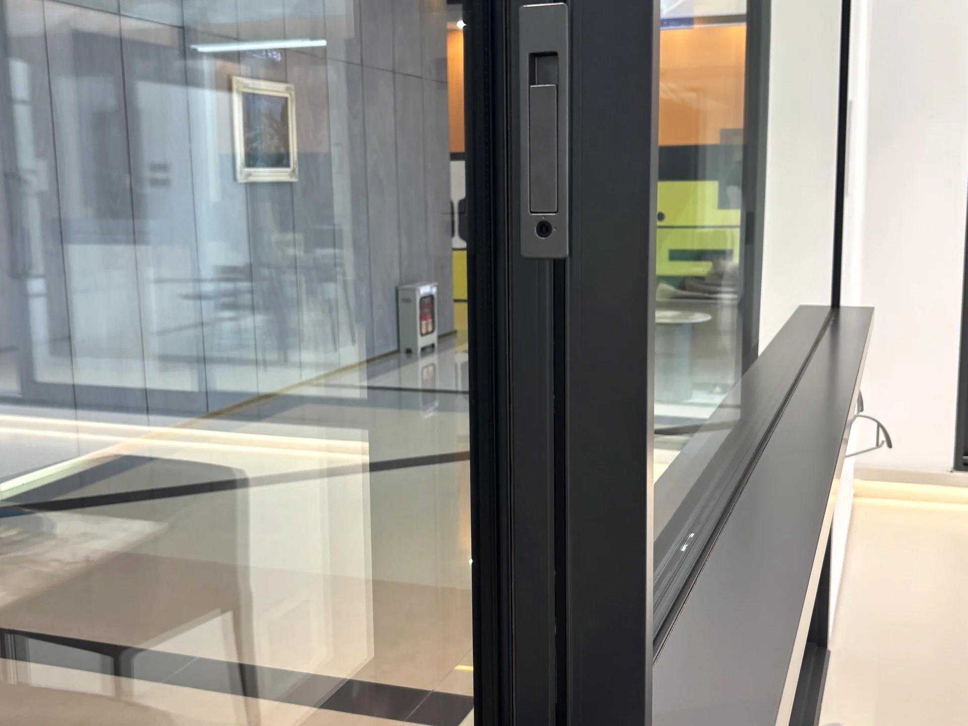 Aluminium door stile, glazing and frame connection in a showroom sample