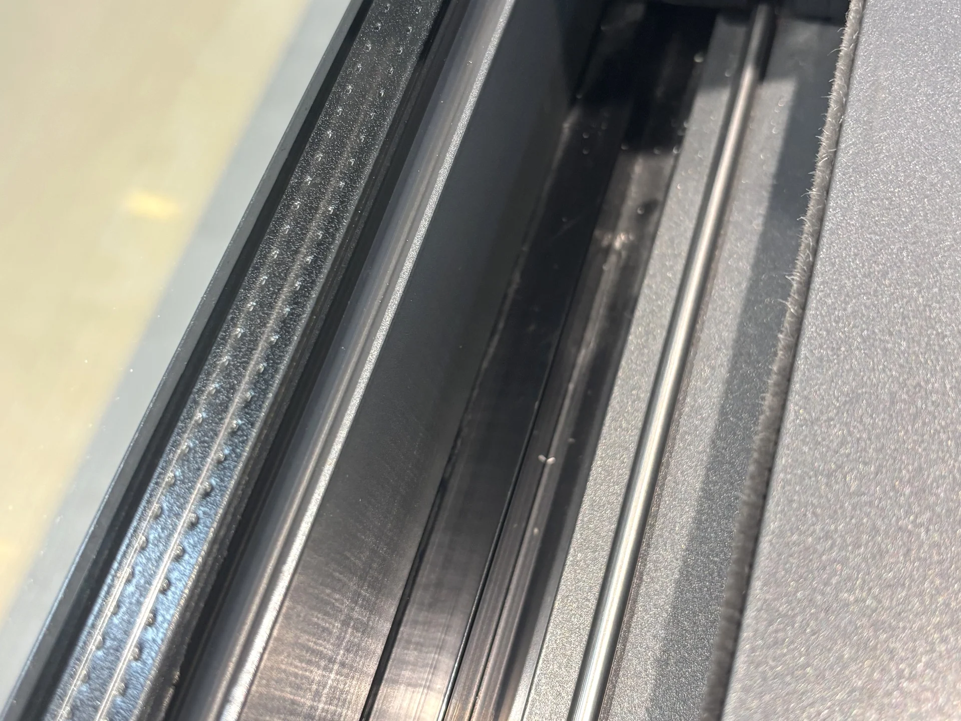 Close detail of aluminium sliding-door track channels