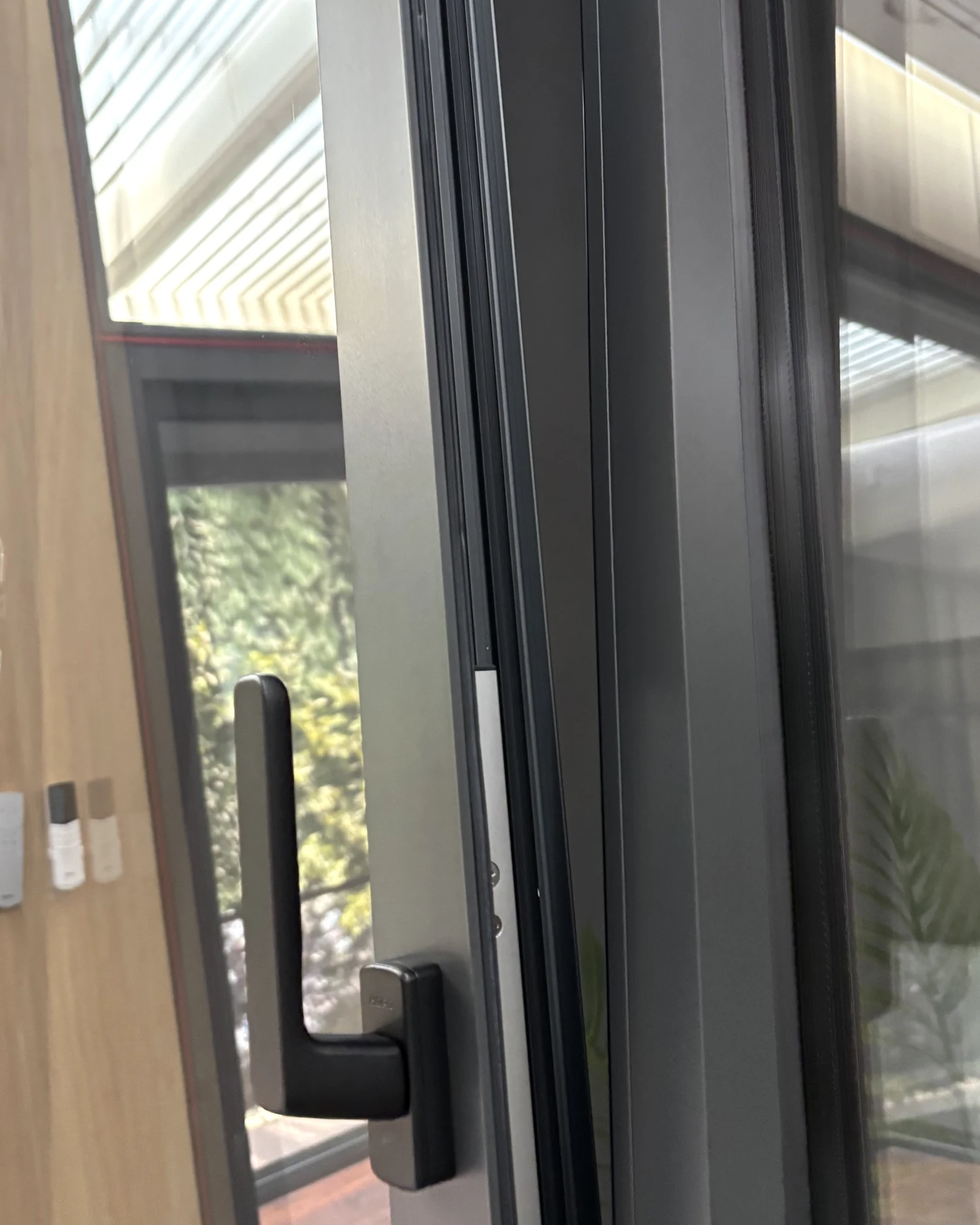 Handle and frame detail on a photographed tilt-and-turn window sample