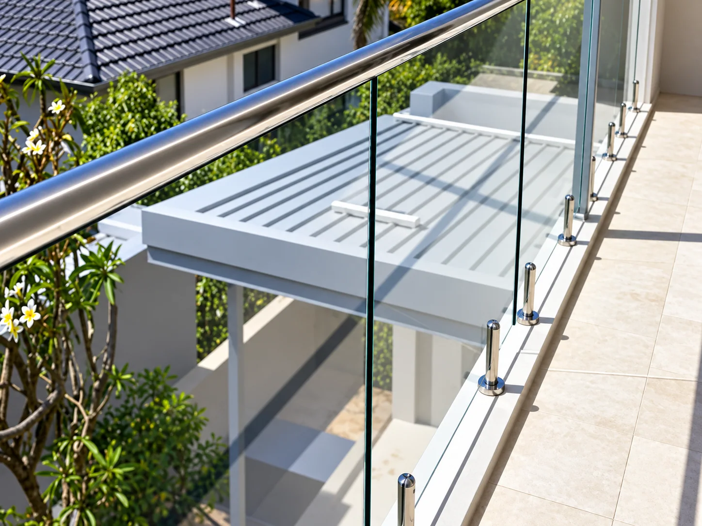Glass balcony railing with posts shown in a supplied product catalogue; series and site not identified