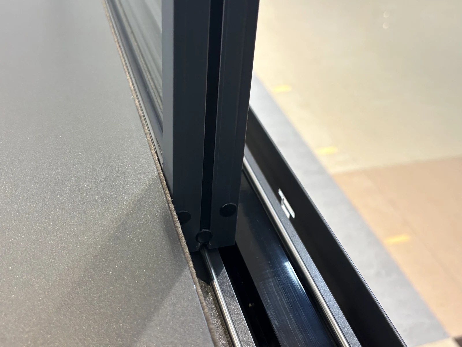 Close detail of a photographed aluminium sliding-door threshold