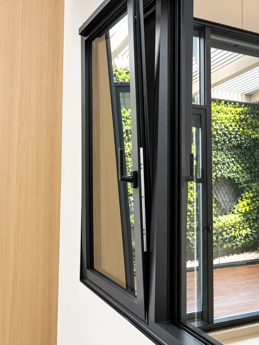 Photographed tilt-and-turn window sample shown open; model and operating positions to confirm